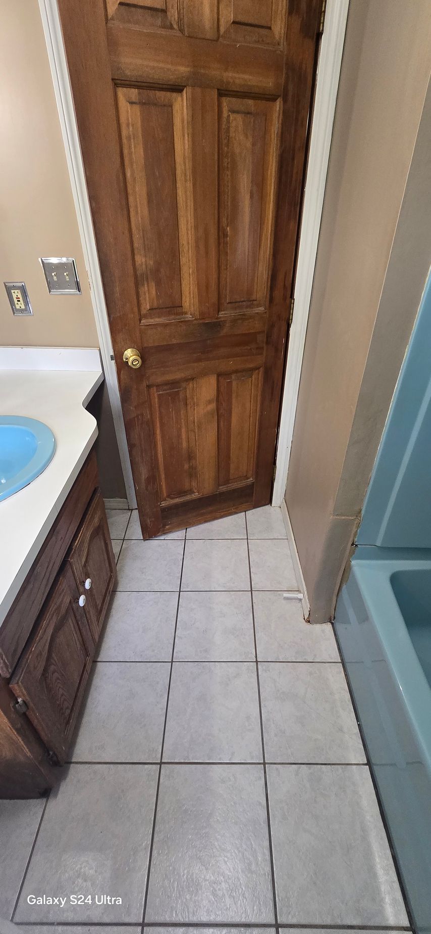 A bathroom under construction with a toilet , sink and window.