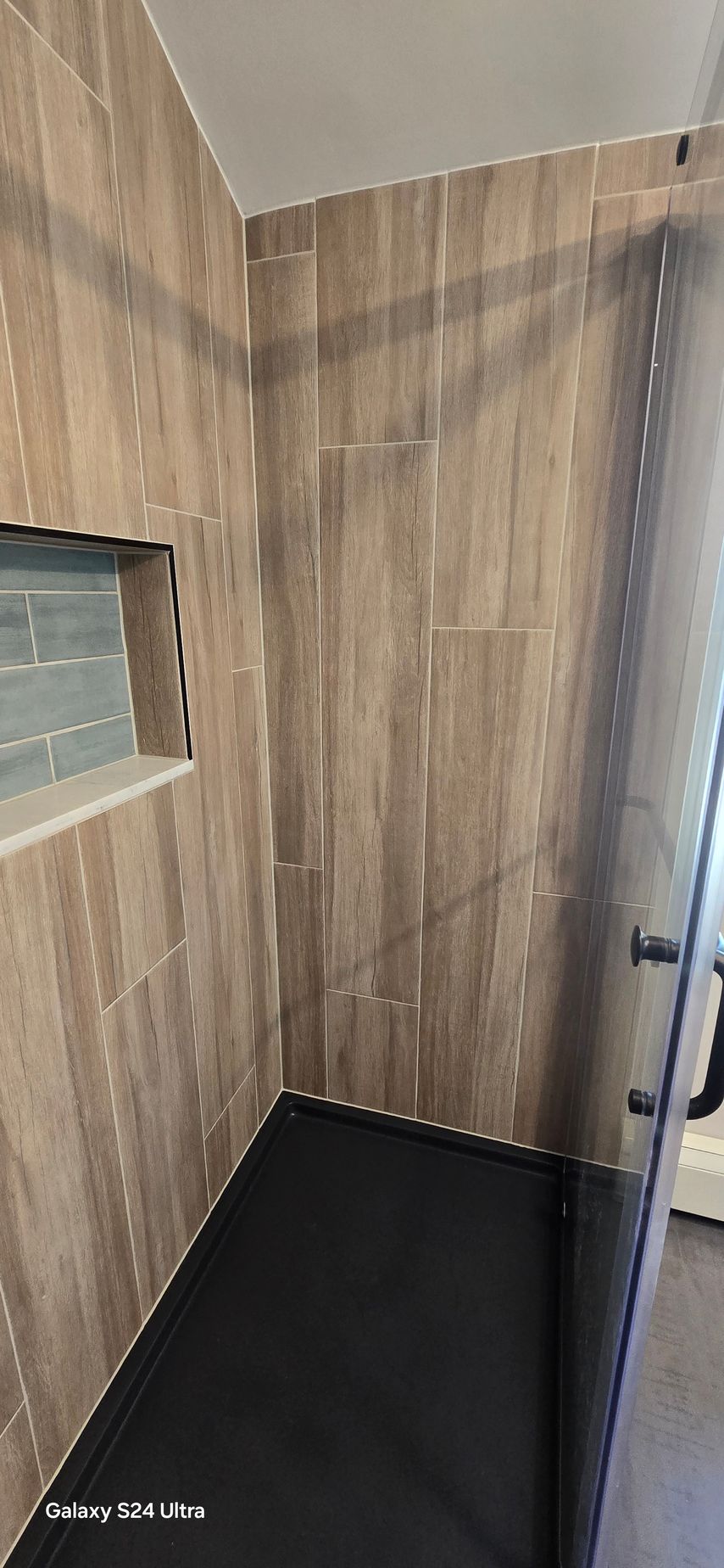 A bathroom with a sink , toilet , and window.