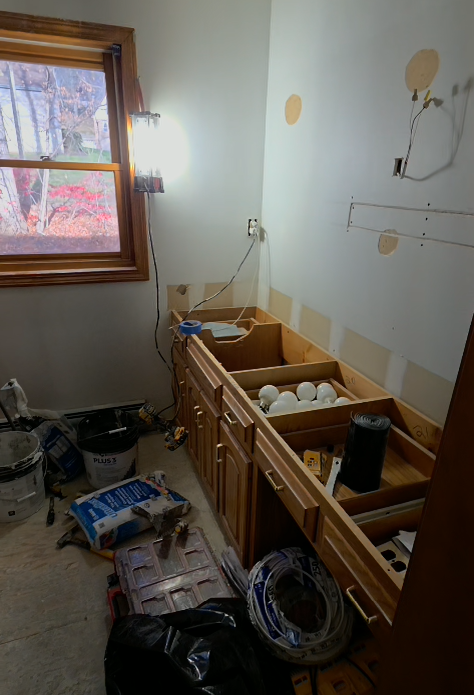 Bristol Bathroom with white bathtub, stone tile shower, black shower fixtures, recessed shelf.