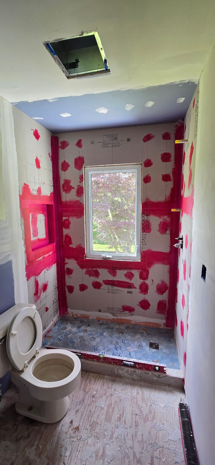 A bathroom with a bathtub and a shower.