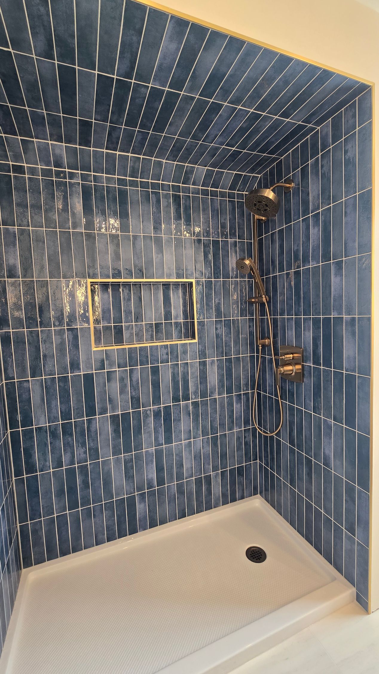 White bathroom with a walk-in shower, a toilet, and a vanity with a vessel sink.
