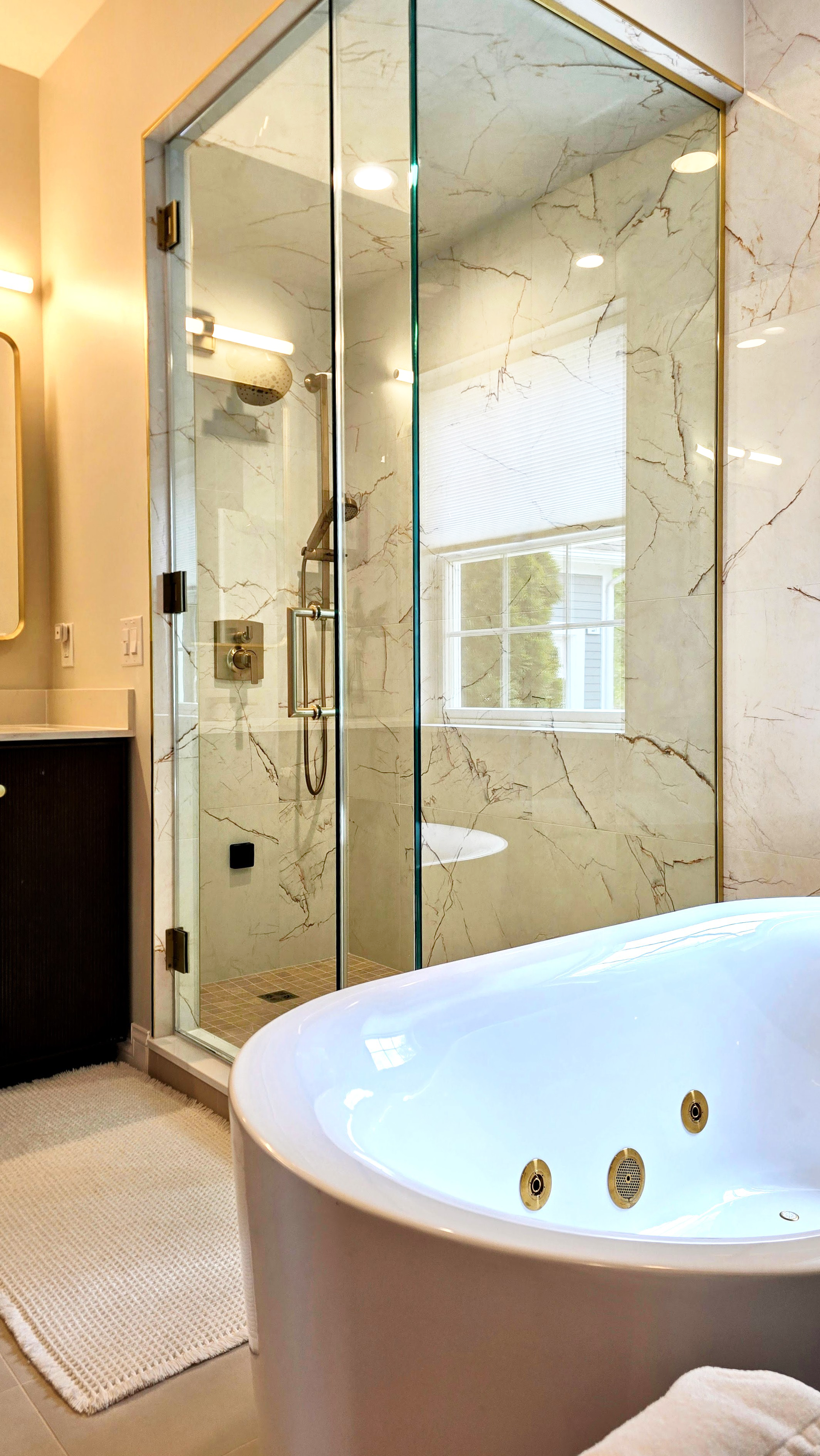 Modern powder room in Simsbury, CT with floating vanity, oval mirror, and patterned accent wall.