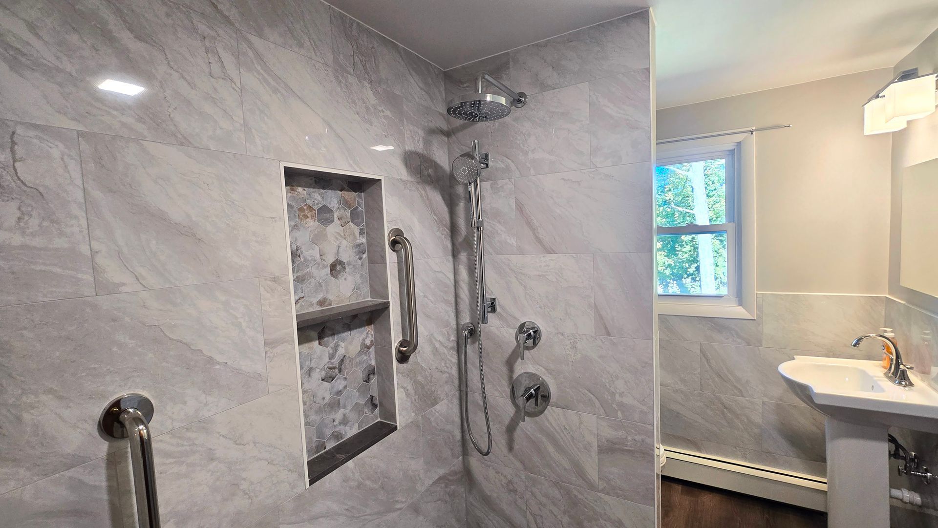 A bathroom with a bathtub and a shower head