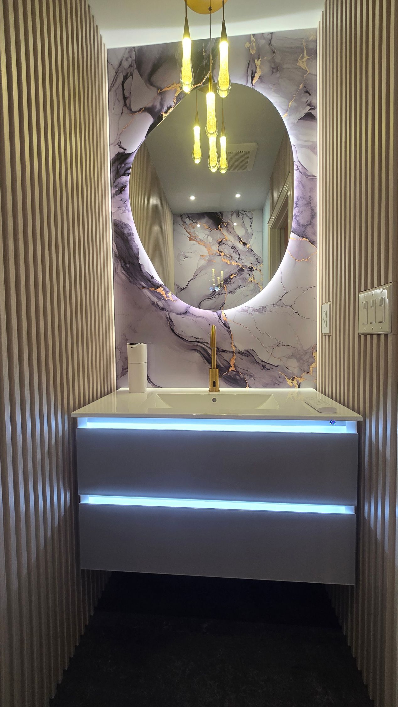 Modern powder room in Simsbury, CT with floating vanity, oval mirror, and patterned accent wall.