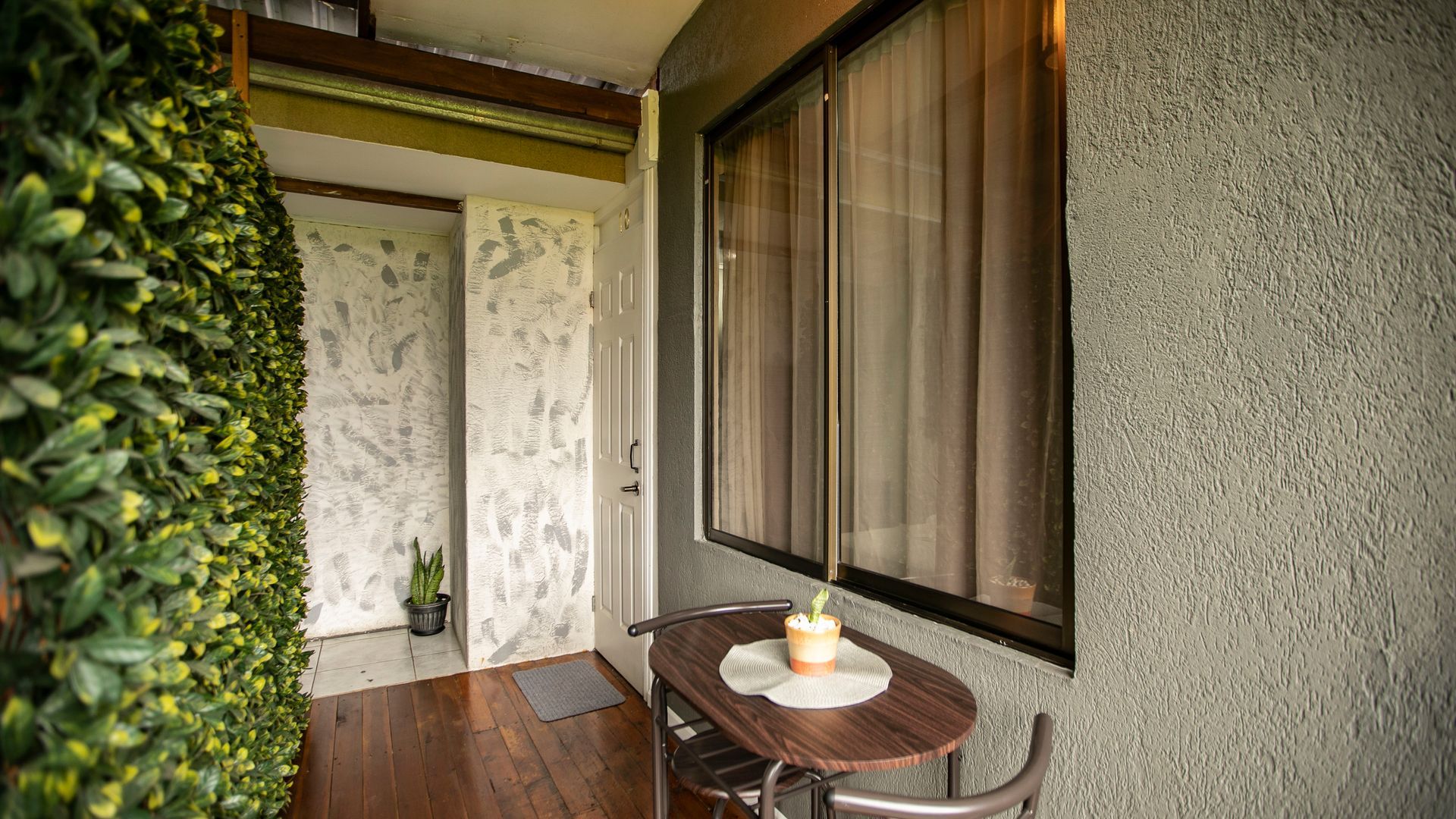 a room with a table and chairs in front of a window .