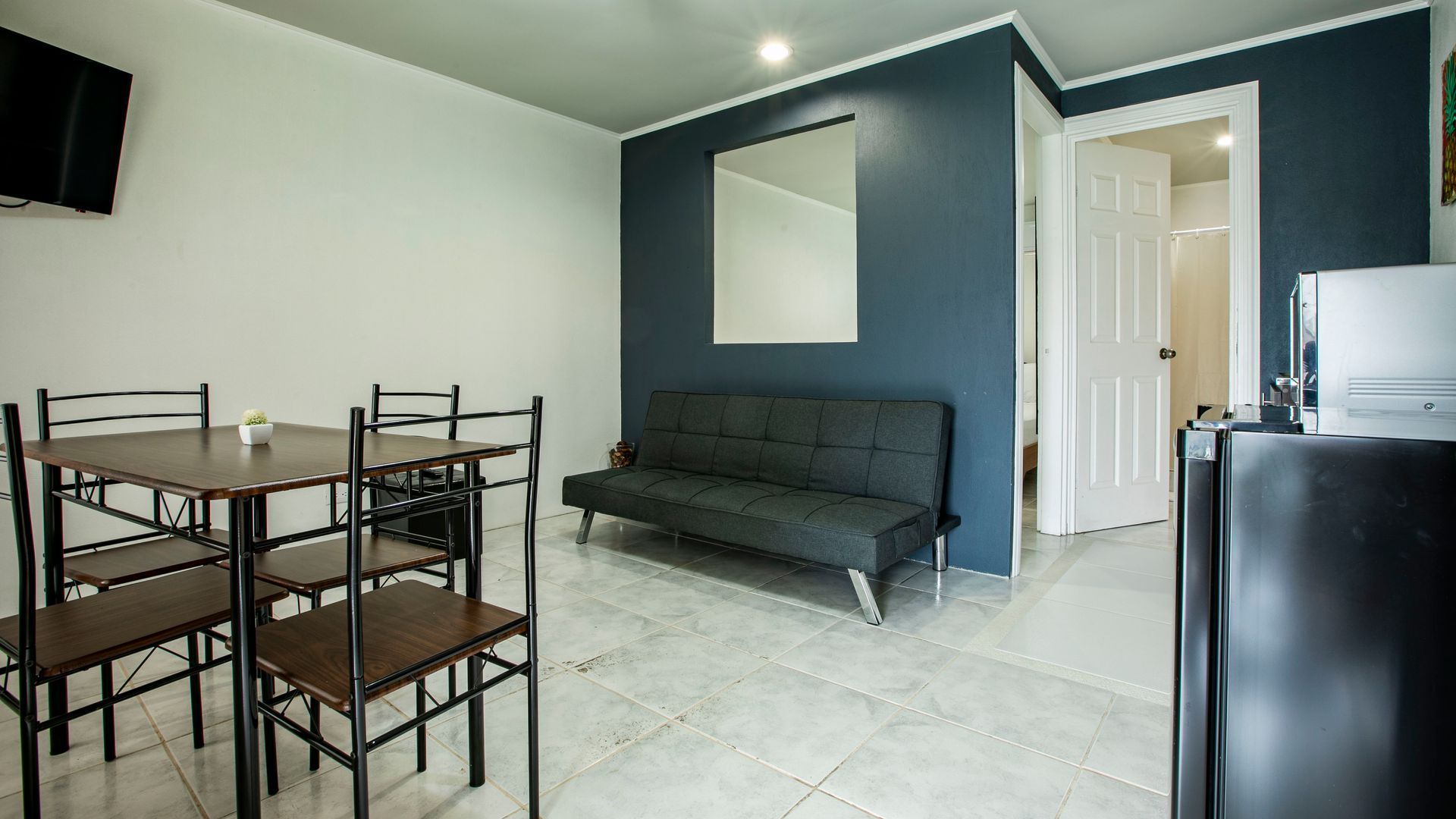 a living room with a couch , table and chairs