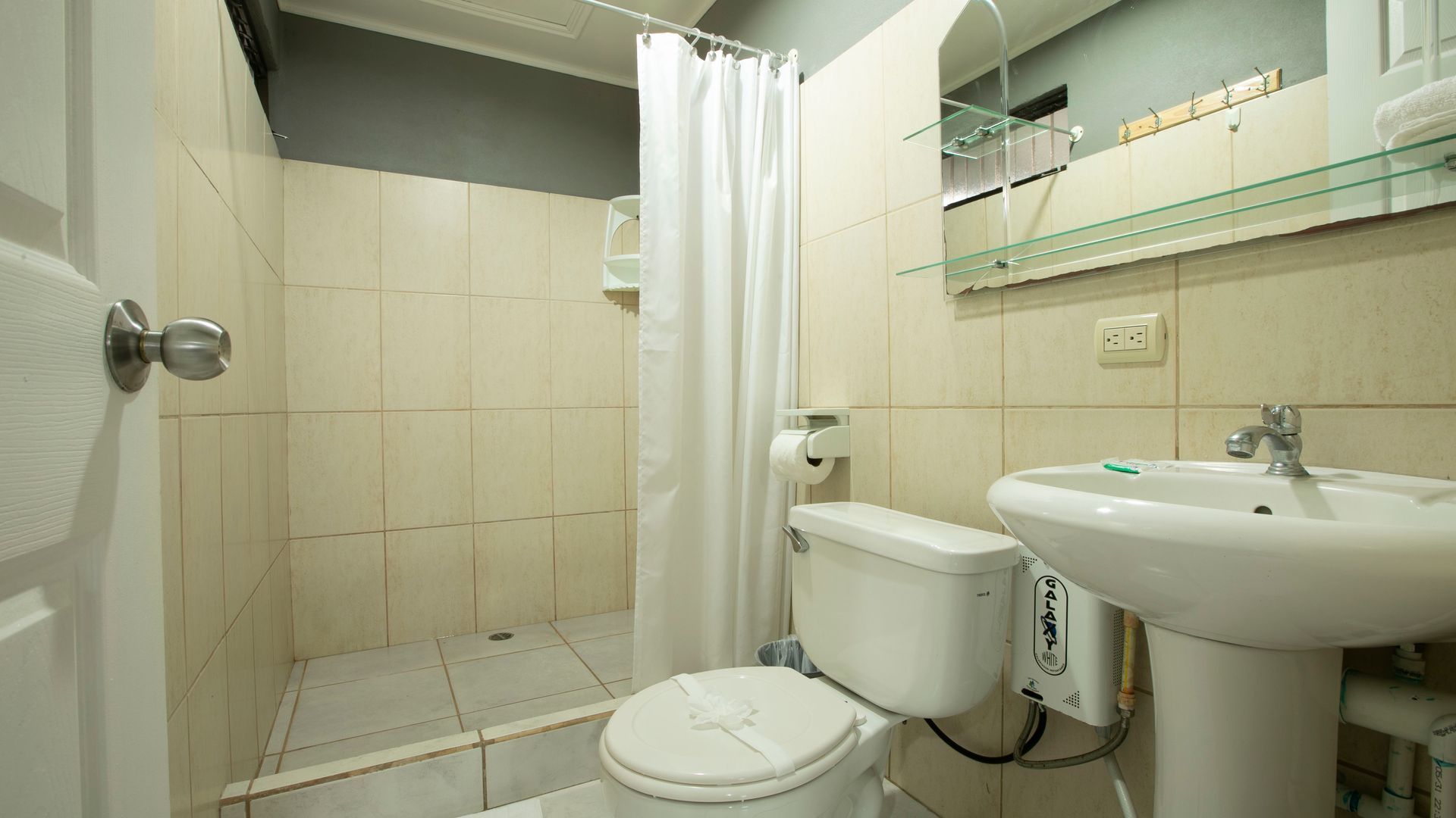 a bathroom with a toilet , sink , and shower .