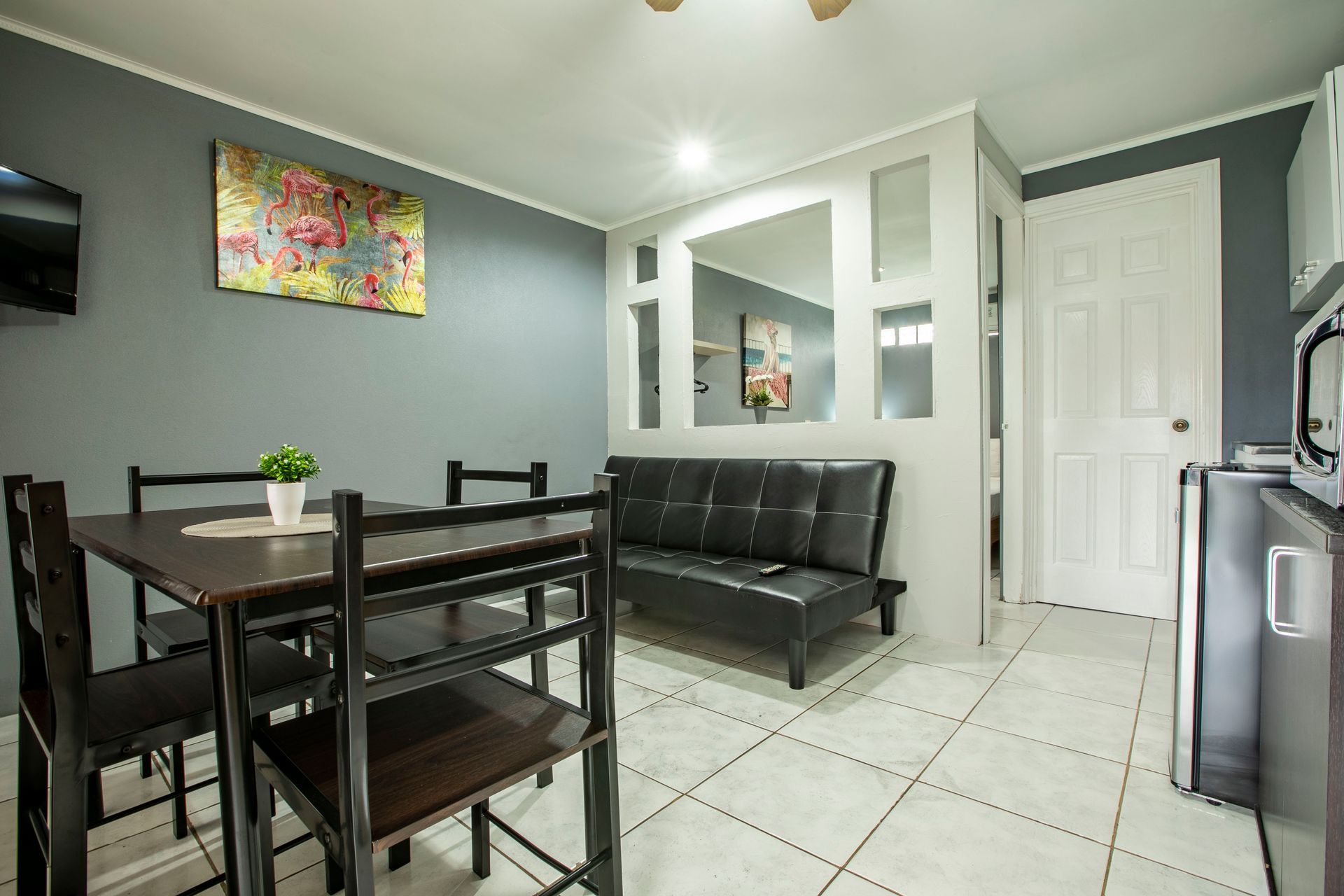 a living room with a couch , table and chairs .