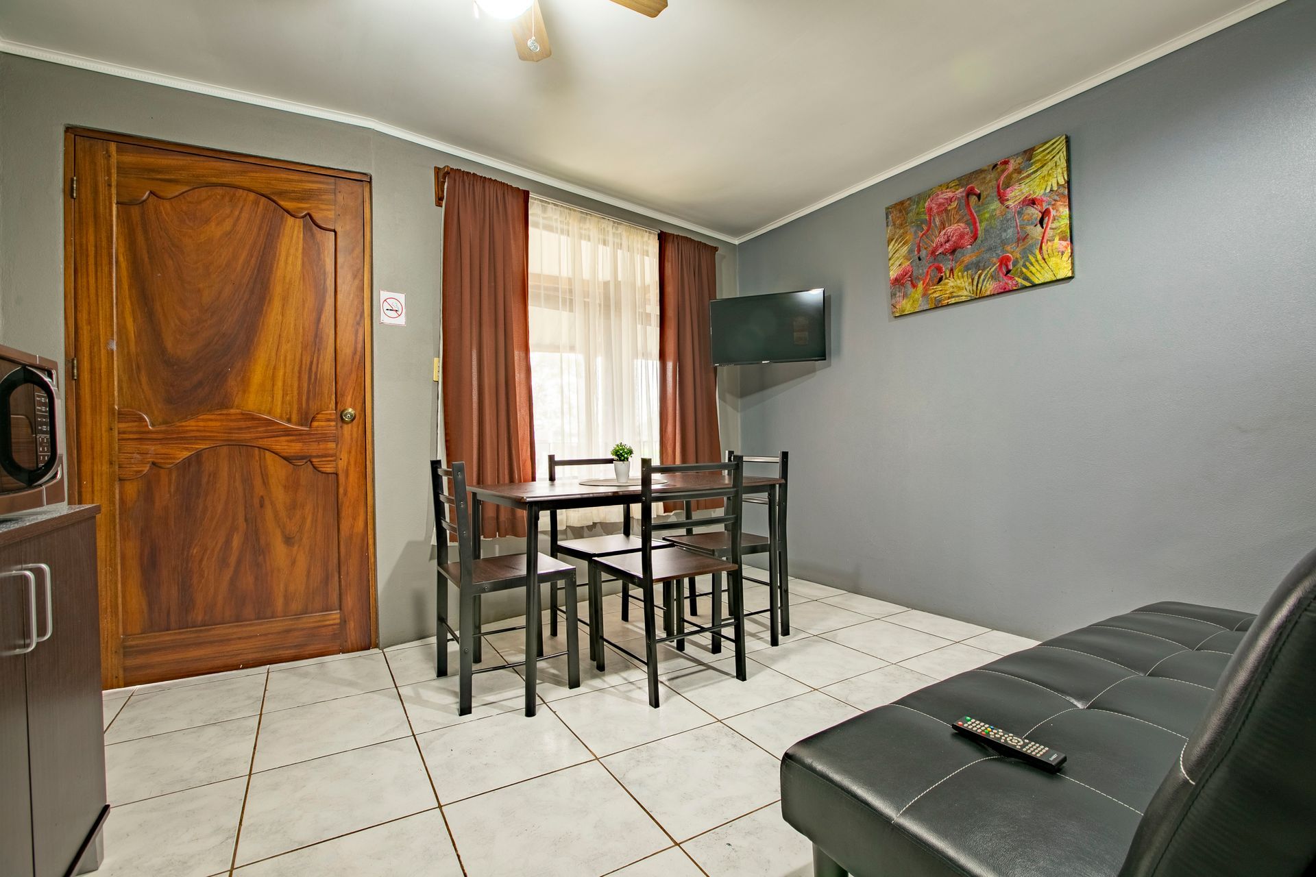 a living room with a table and chairs and a couch .