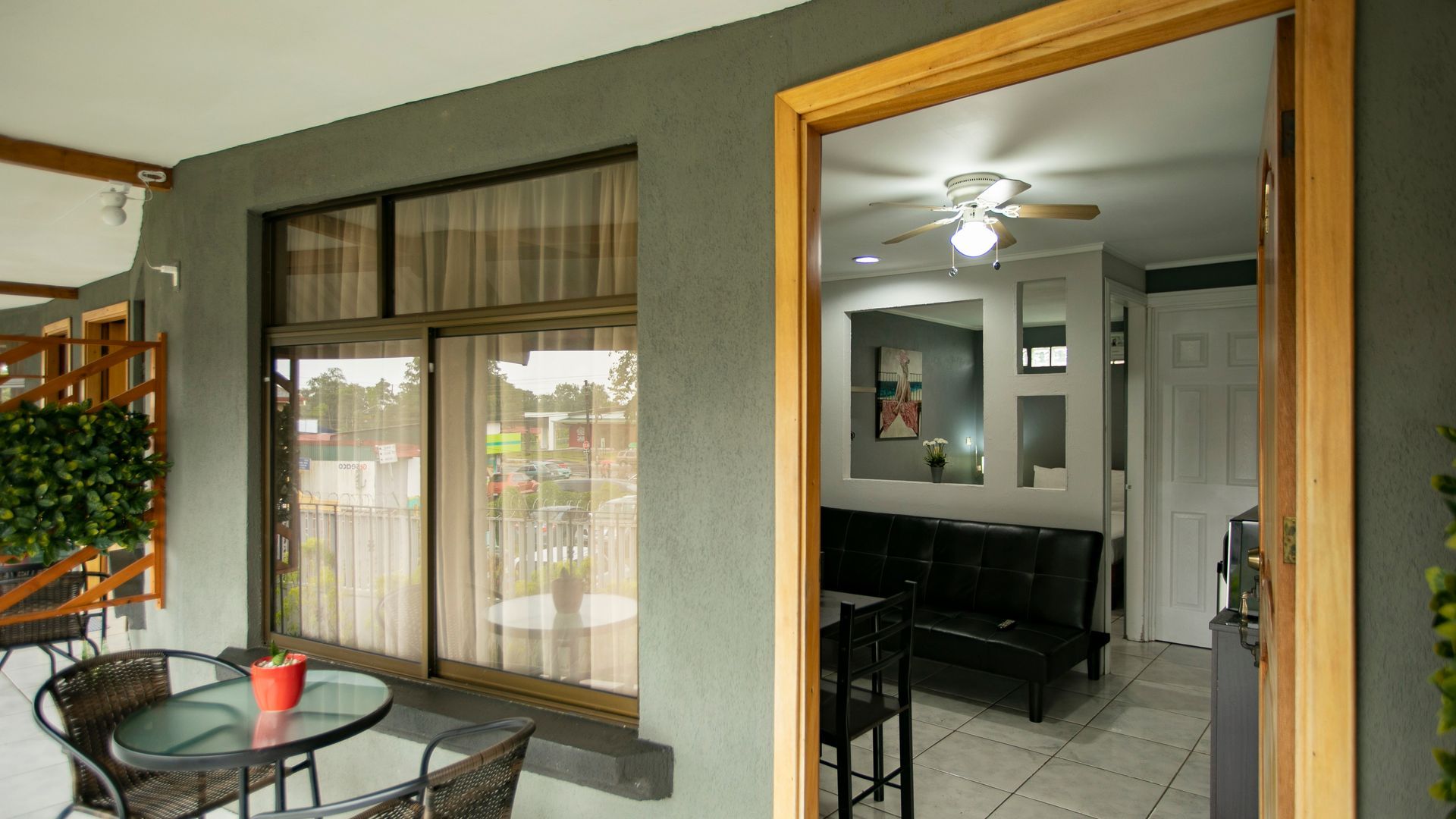 a patio with a table and chairs and a ceiling fan