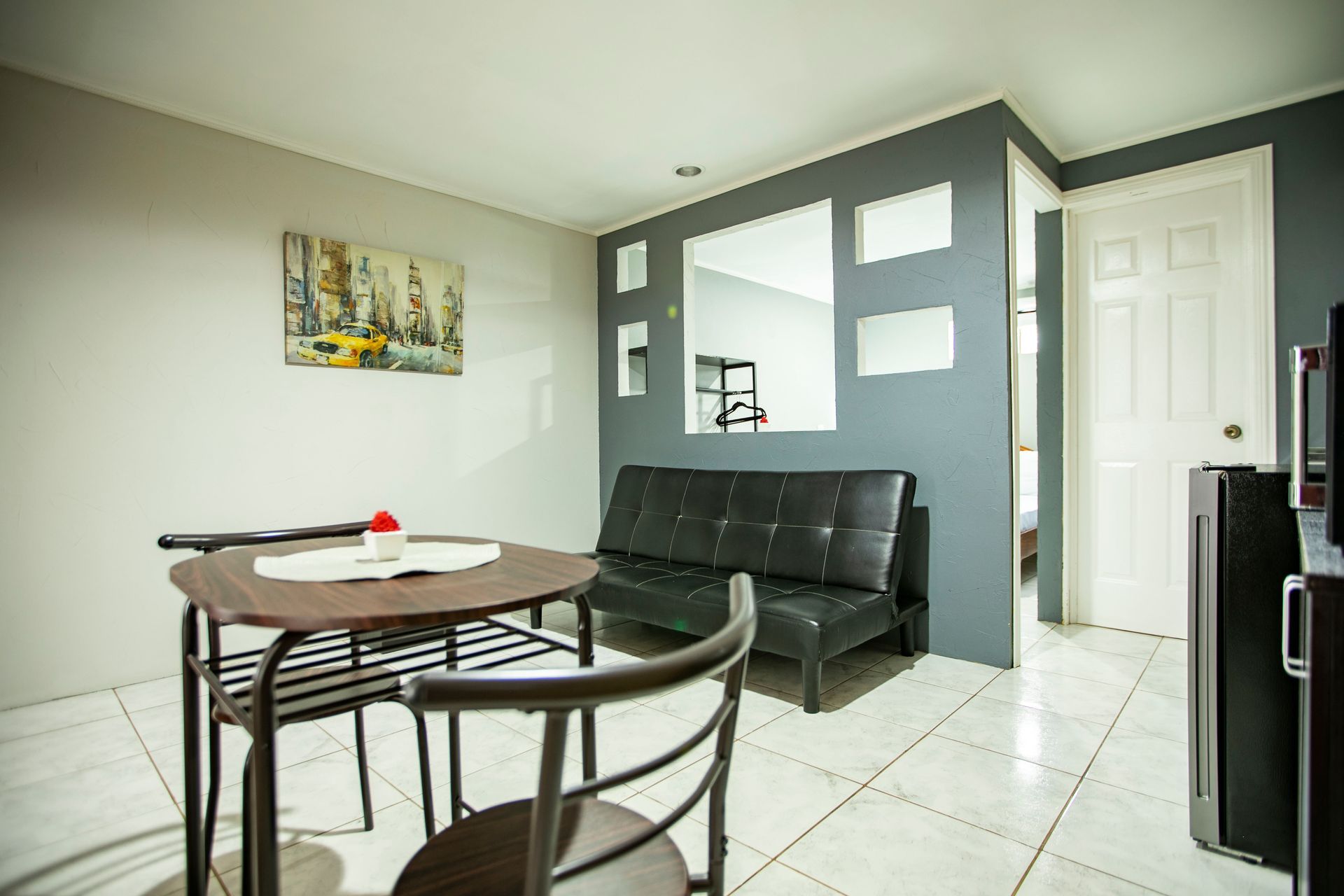 a living room with a table and chairs and a couch
