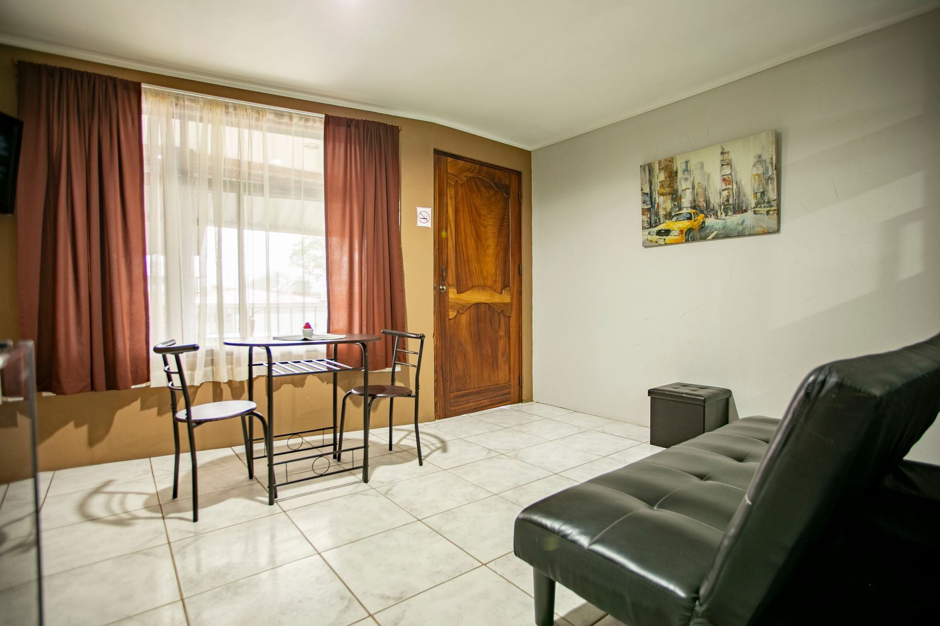 a living room with a couch , table and chairs