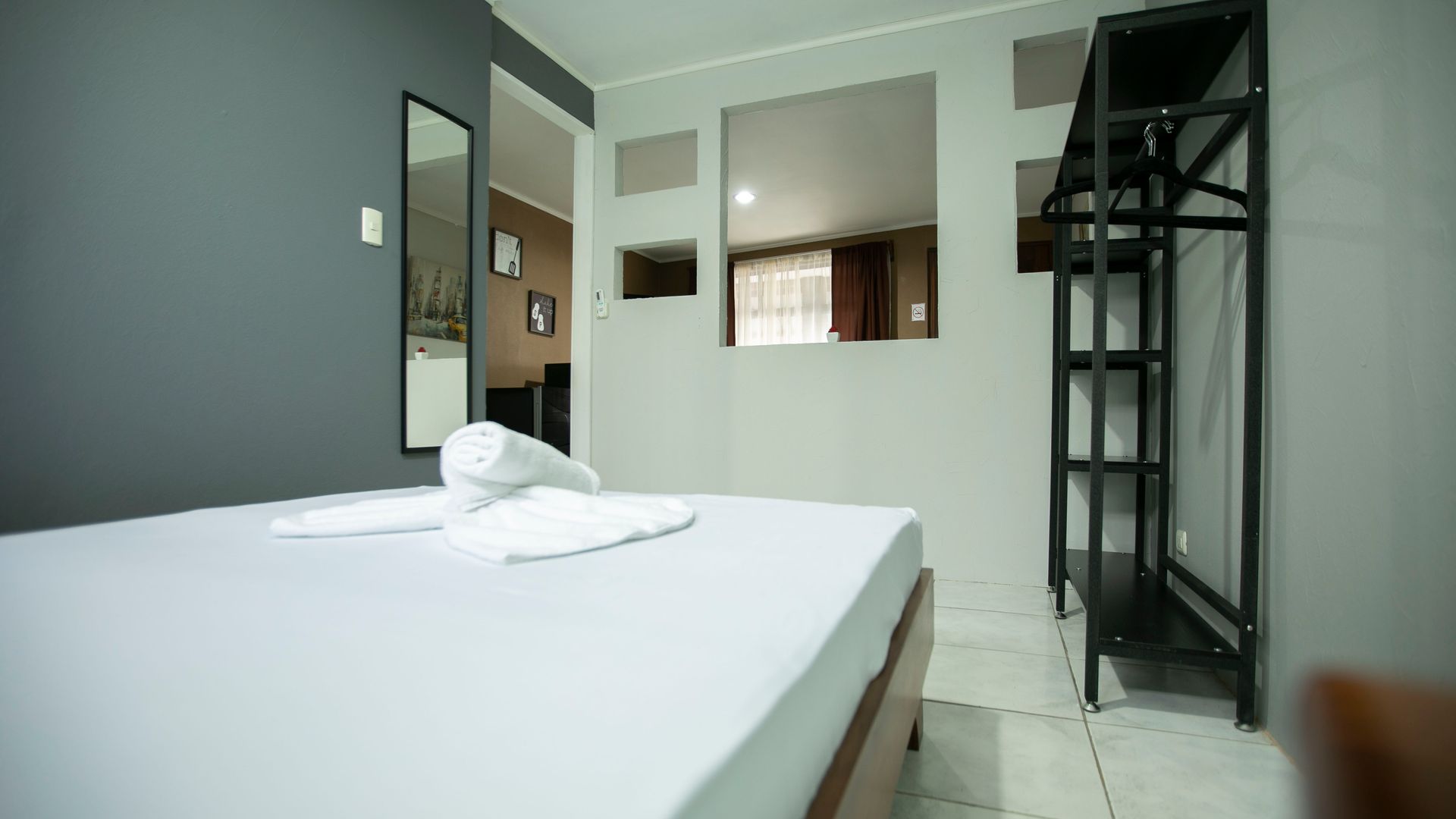 a hotel room with a bed and a mirror