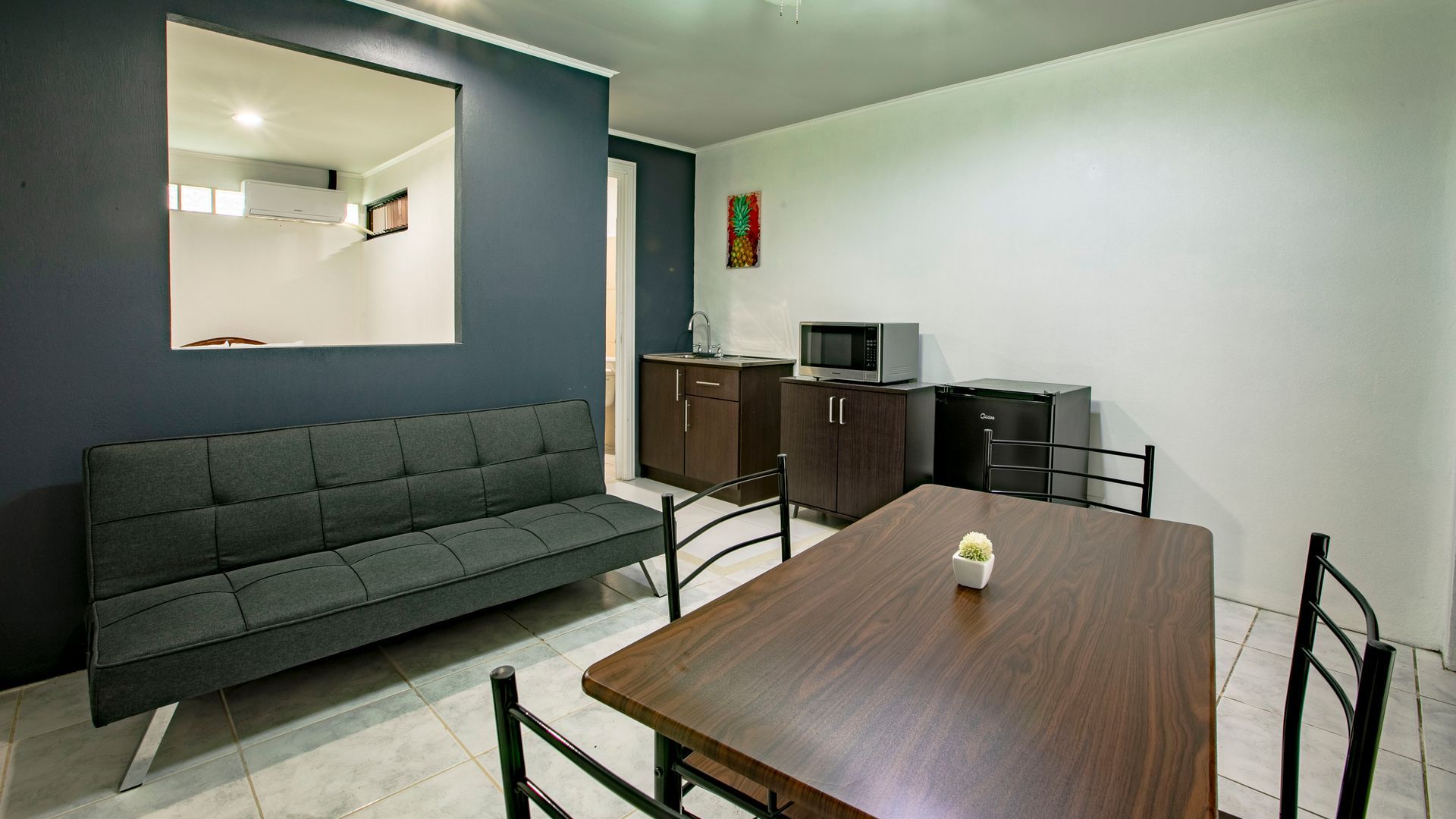 a living room with a couch , table and chairs .