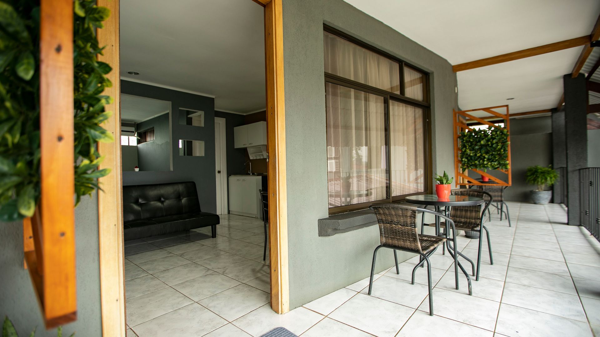 a balcony with a table and chairs and a couch .