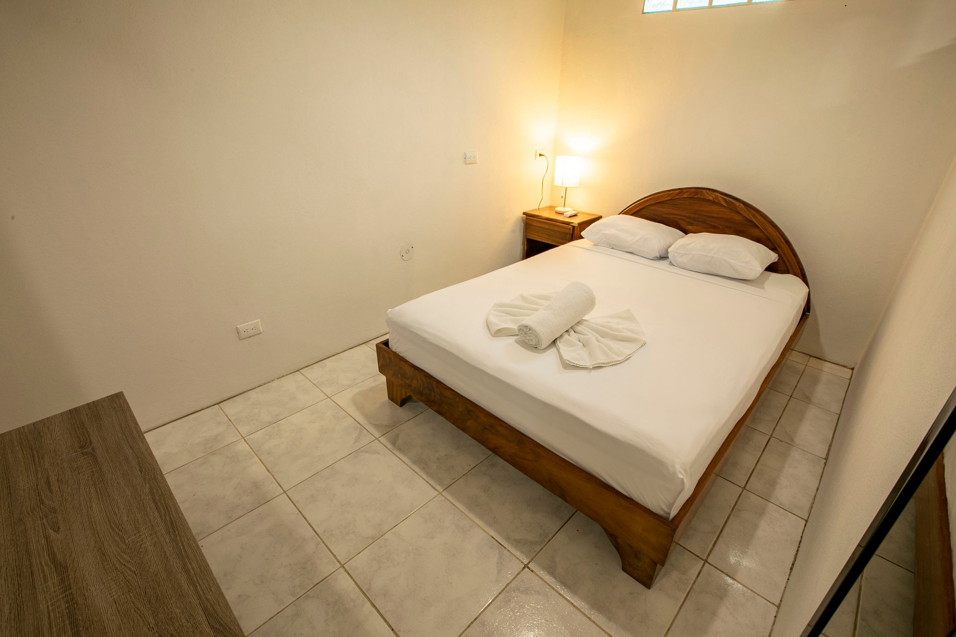 a bedroom with a bed and a nightstand in it