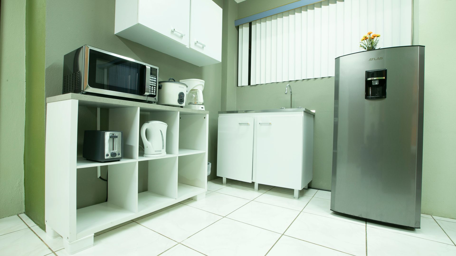 a kitchen with a stainless steel refrigerator and a microwave