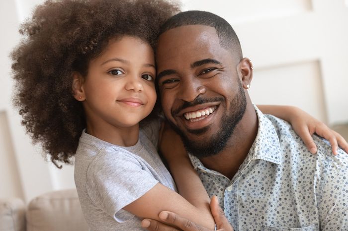 Happy affectionate african american family young daddy and small cute child daughter