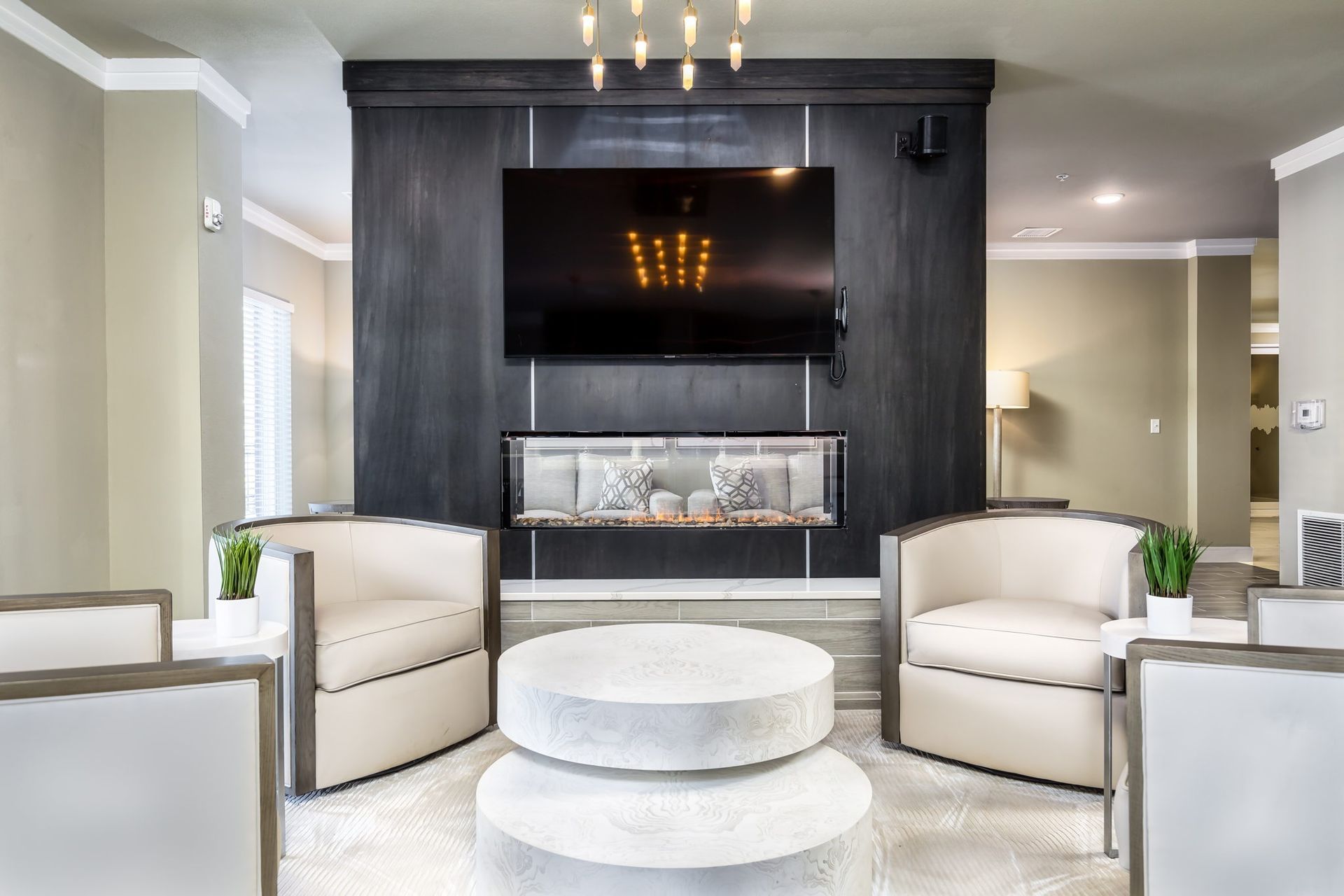 A living room with a fireplace and a flat screen tv.