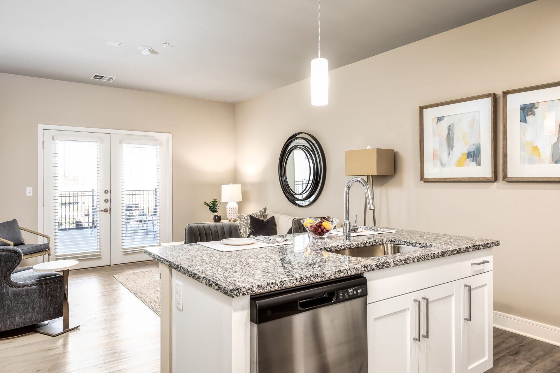 A kitchen with granite counter tops , stainless steel appliances , and a large island.
