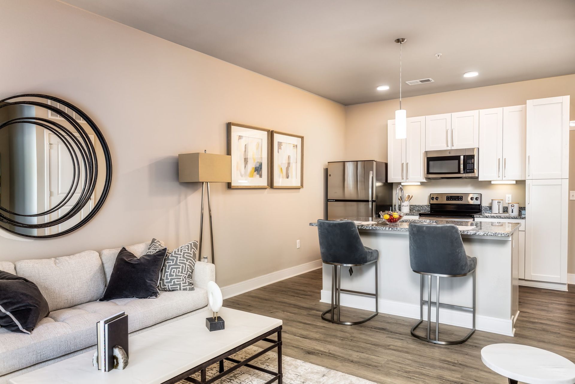 A living room with a couch , coffee table , and kitchen.