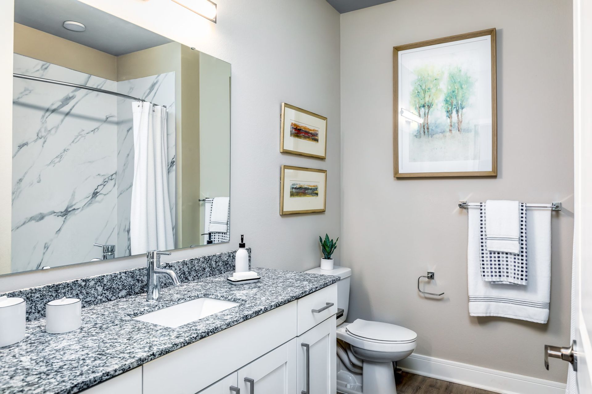 A bathroom with a sink , toilet , and mirror.