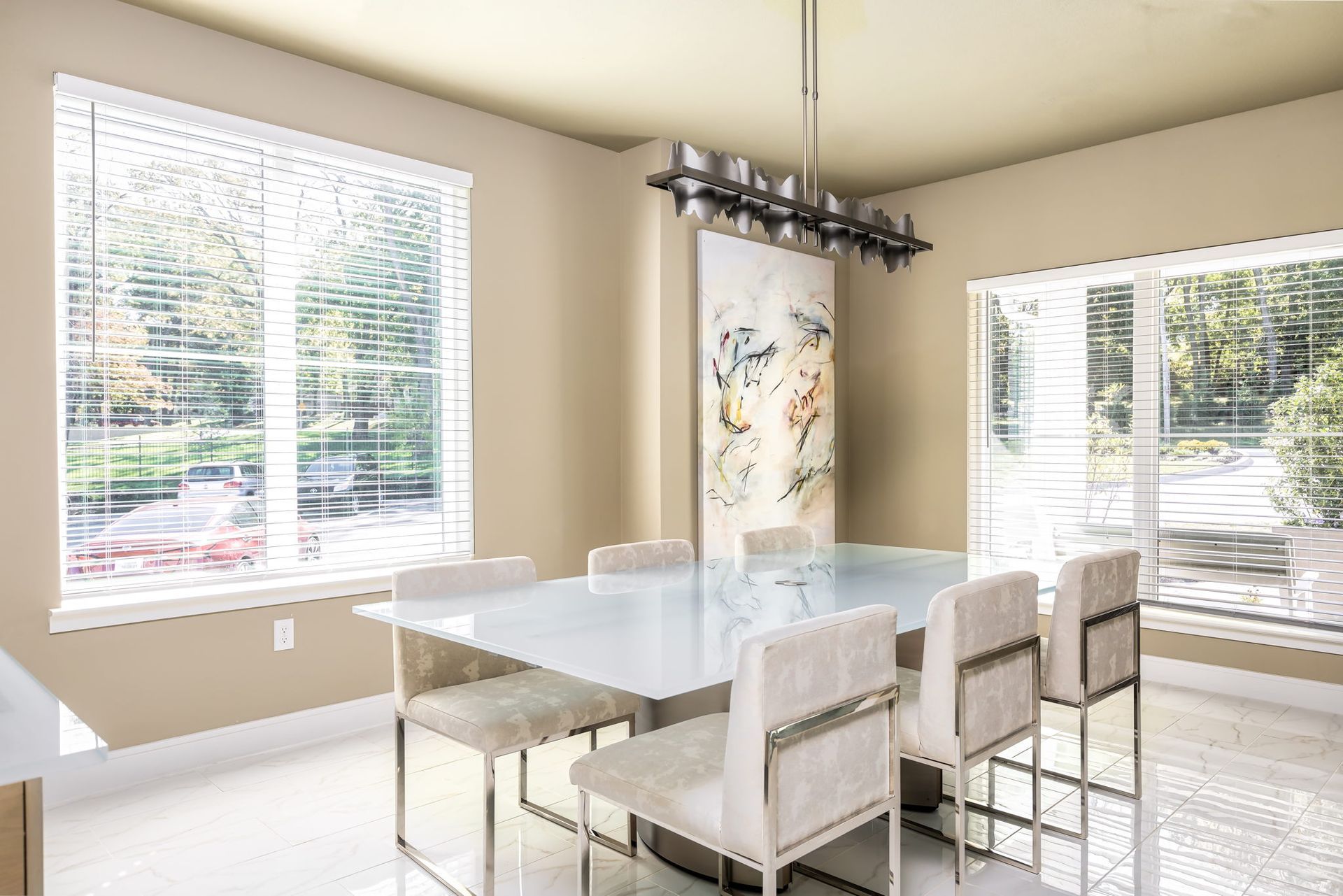 A dining room with a table and chairs and a chandelier.