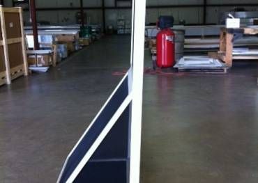 A warehouse with a red fire extinguisher on the floor