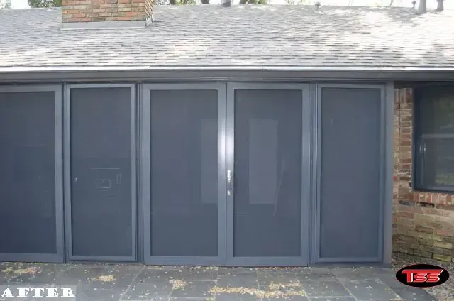 A picture of a house with a screened in garage door
