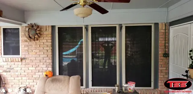 A living room with a ceiling fan and a couch.