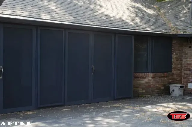 A picture of a garage door that has been painted black.