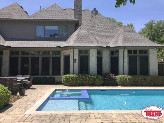 A large house with a swimming pool in front of it