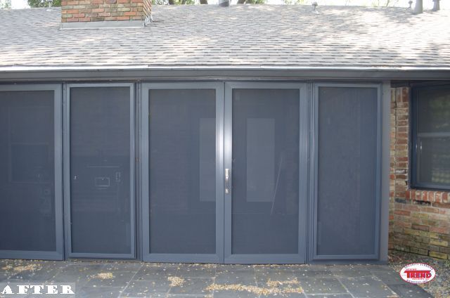 A picture of a house with a screened in garage door