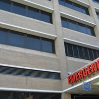 A large building with a sign that says `` emergency '' on it.