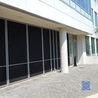 A large building with a lot of windows and a patio in front of it.