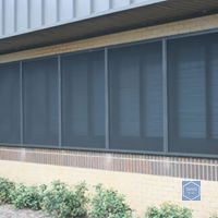 A building with a lot of windows with screens on them.