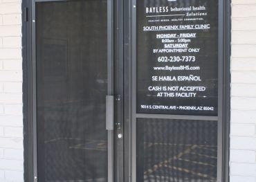 A door with a sign that says bayless on it