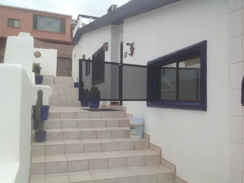A white building with stairs leading up to it