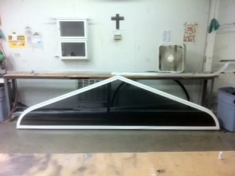 A cross is on the wall above a table in a room