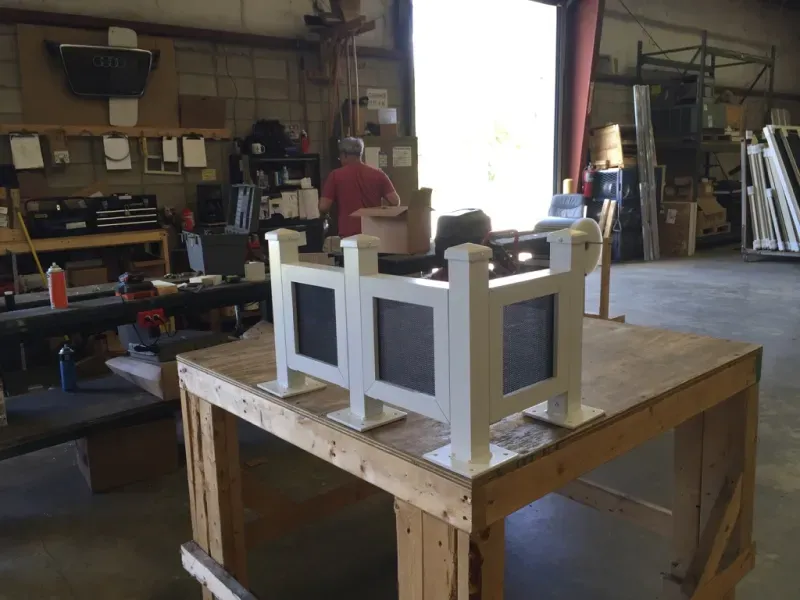 A wooden table with a chalkboard on it in a workshop.