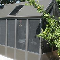 A screened in porch with a solar panel on the roof.