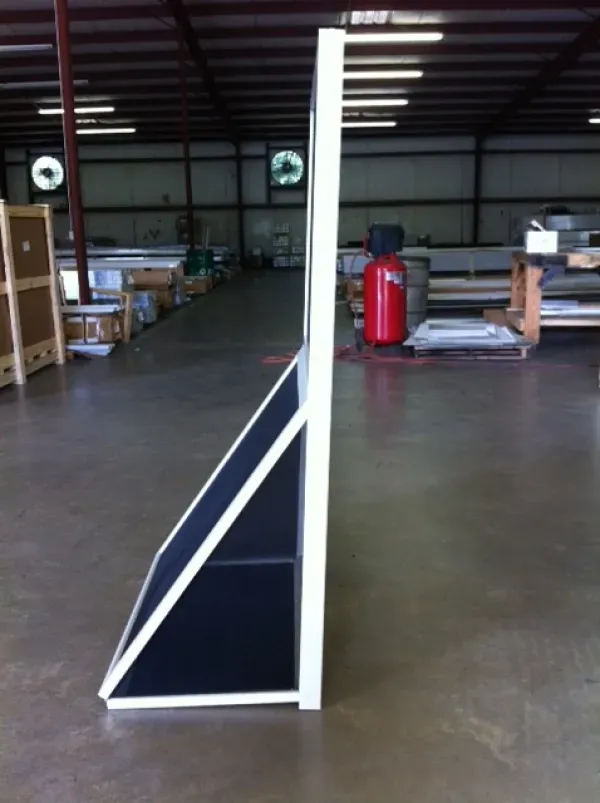 A red fire extinguisher sits in the middle of a warehouse