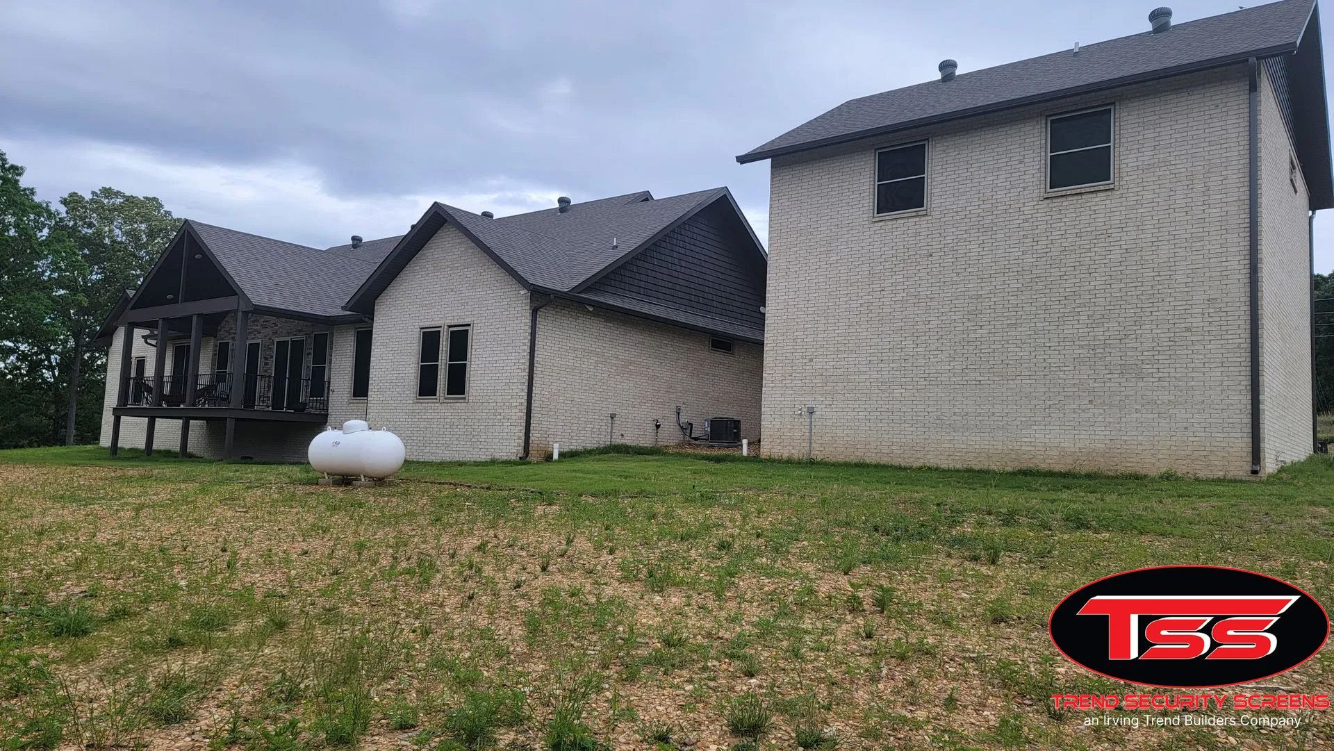 A large brick house with white shutters and columns