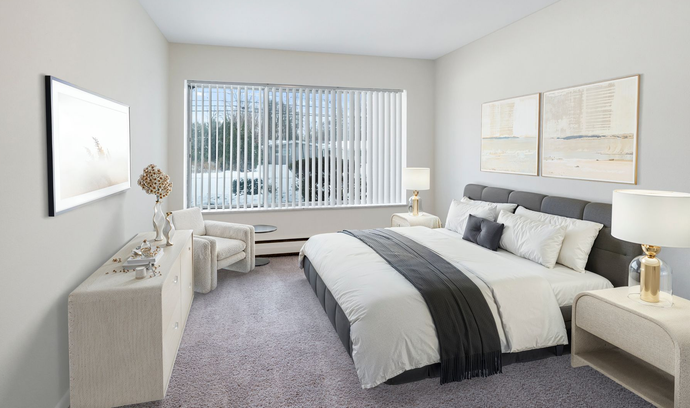 Bright bedroom with a large bed, gray carpet, white walls, and a window with vertical blinds