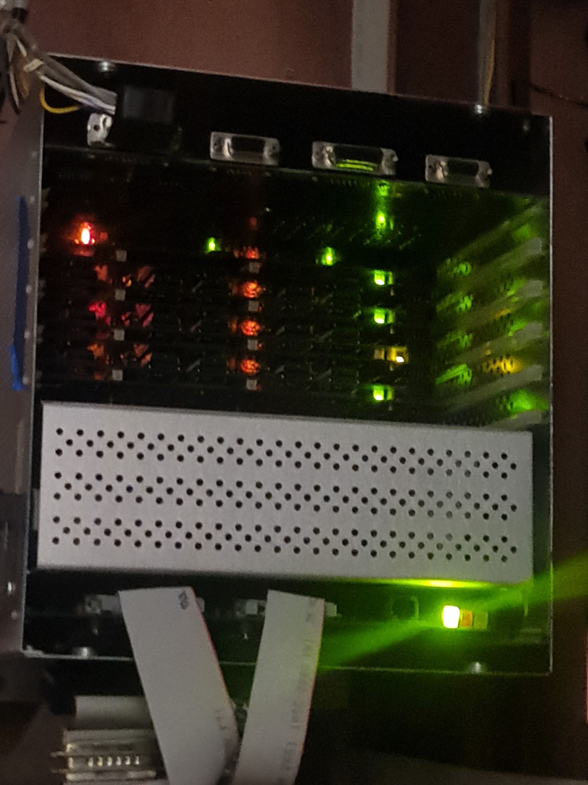 Server rack with rows of circuit boards and blinking lights.