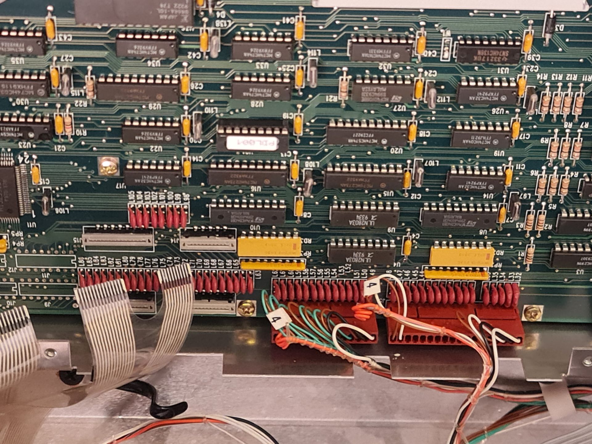 Circuit board with rows of electronic components and wiring.