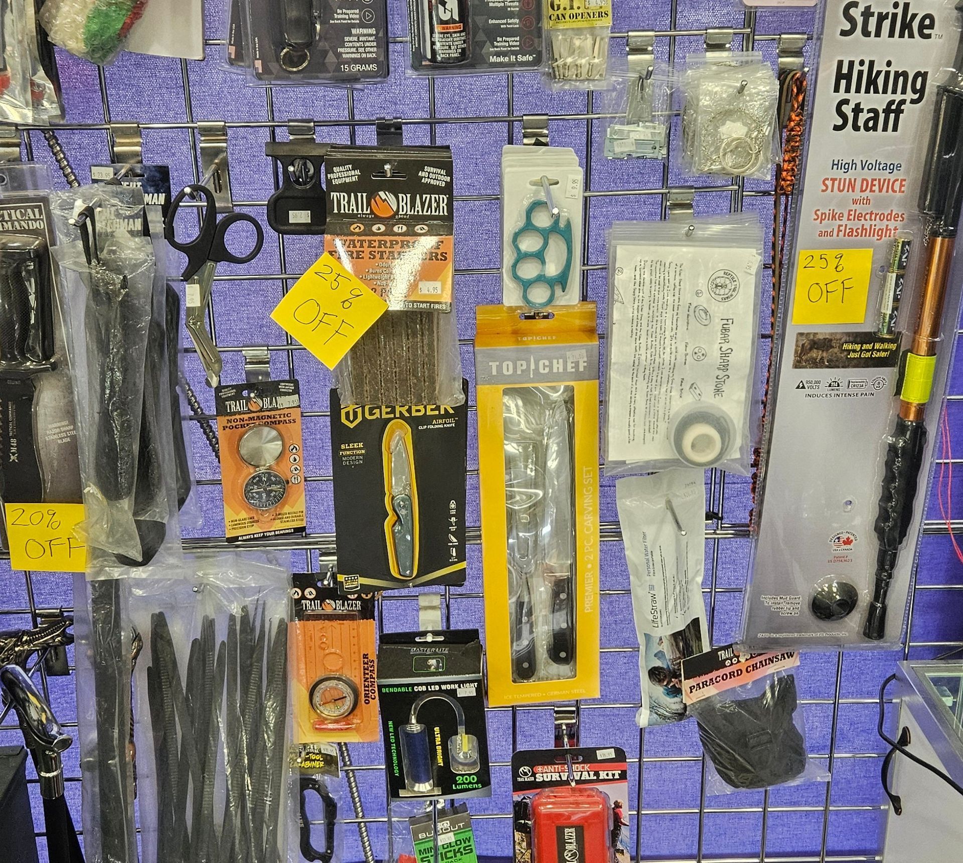 A wall featuring several outdoor and survival related items.