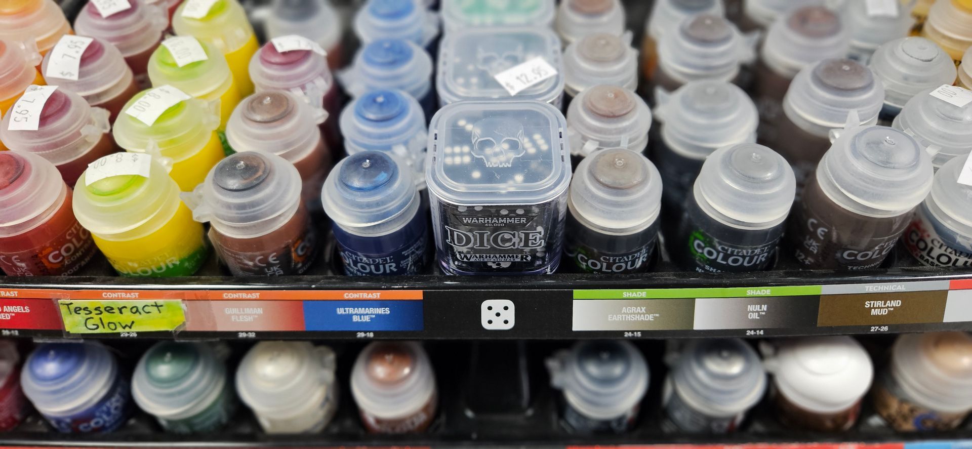 A close up image featuring a rainbow of Warhammer paints.