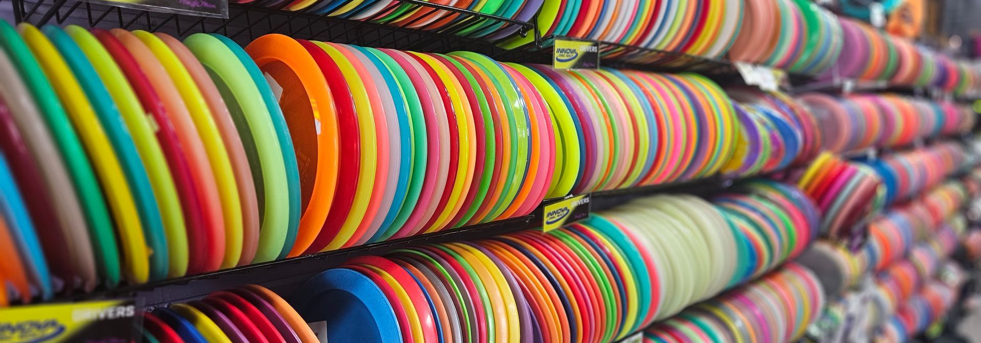 A stunning array of disc golf discs with row upon row fading into the distance.