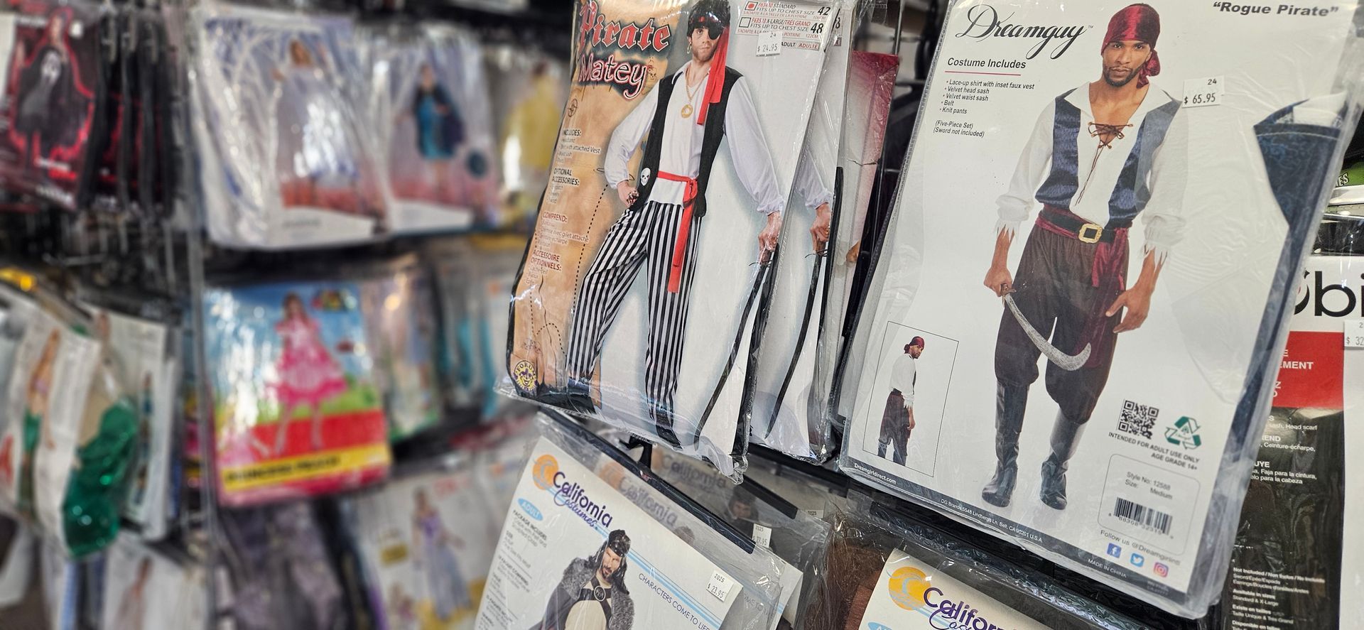 Costume racks featuring pirates and vikings, the other displaying various Disney Princess costumes.
